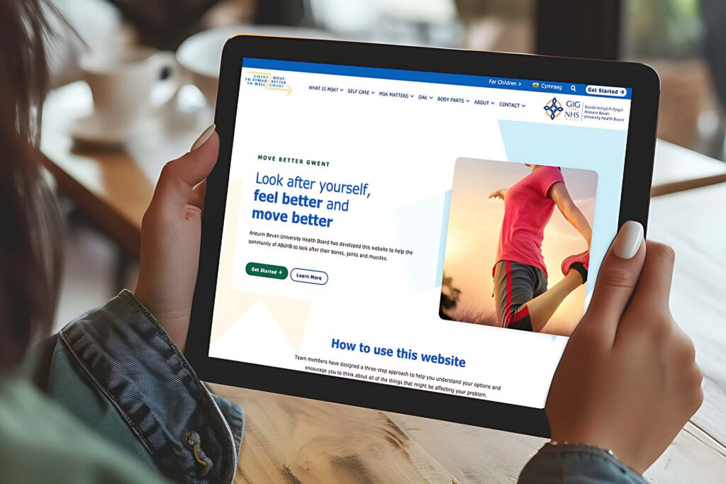 Hands holding a tablet showing the Move Better Gwent NHS Wales website
